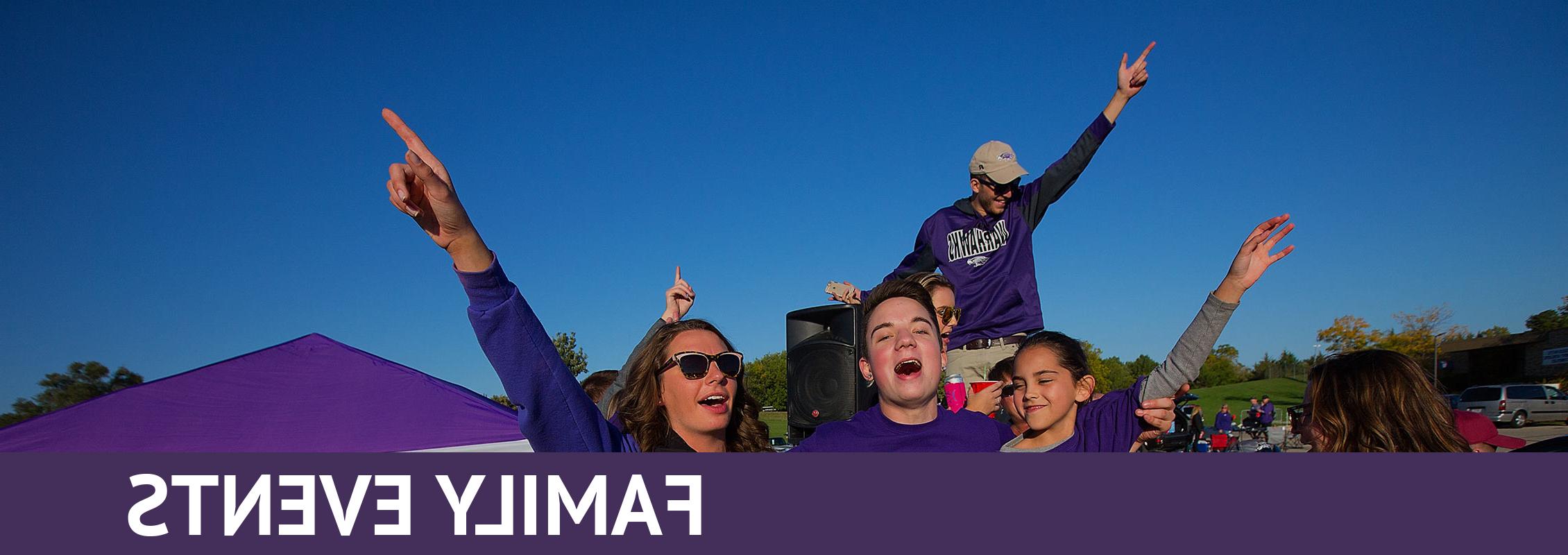 家庭活动:一家人穿着紫色衣服，唱着歌或喊着，双手高举